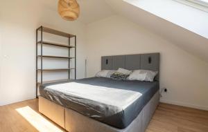 a bedroom with a large bed in a attic at Appartement Proche Touquet in Étaples