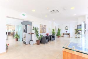 an empty lobby with potted plants in a building at Casa Do Vale Hotel by Umbral in Évora +46 photos