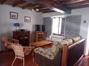 a living room with a couch and chairs and a table at Romallande in Cabrafigal