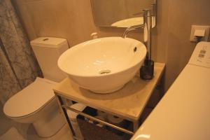a bathroom with a white sink and a toilet at Central cozy studio in Agios Nikolaos +12 photos