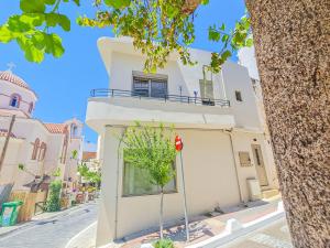 a white building with a stop sign in front of it at Central cozy studio in Agios Nikolaos