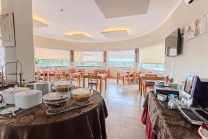 a dining room with a table with food on it at Casa Do Vale Hotel by Umbral in Évora