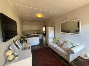 a living room with a couch and a kitchen at 13 bedford street in Grahamstown