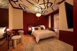 a bedroom with a bed with a painting on the ceiling at TWENTYSEVEN Boutique in Budapest