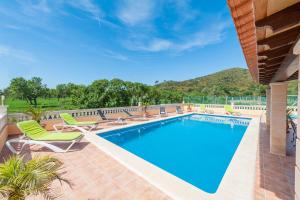 una piscina con tumbonas y un complejo en Villa Bona Vista en Capdepera
