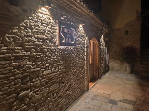 a stone building with a clock on the side of it at Mercato29Home in Lucera