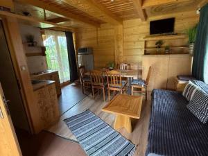 a living room with a table and a dining room at Domki u Teresy in Dębno +7 photos