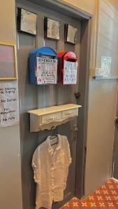 a room with a shelf with a shirt and baskets at Roomah En-suite attached-bath R6 in Ipoh