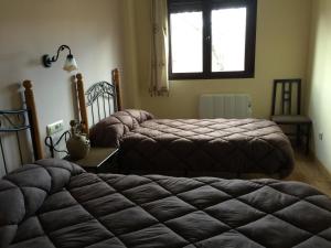 Llit o llits en una habitació de Apartamentos Sanabria