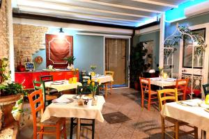 a restaurant with tables and chairs in a room at Flow Urban Living by DiffeRent in Ferrara