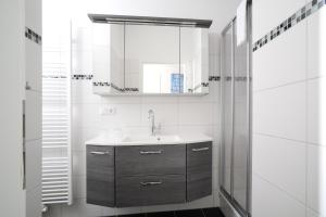a bathroom with a sink and a mirror at Le petit Palais - Apartments in Bad Suderode +48 photos