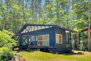 a small blue tiny house in the woods at イーリス軽井沢 in Naganohara +14 photos