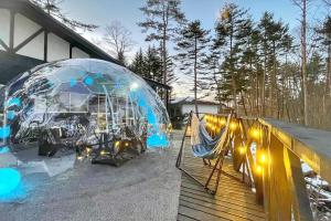 a igloo with lights in it next to a house at イーリス軽井沢 in Naganohara
