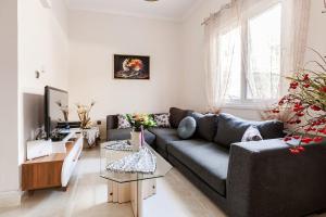 a living room with a couch and a table at Enora Loutraki Guesthouse in Loutraki
