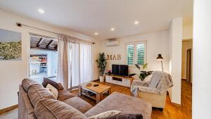 a living room with a couch and two chairs and a tv at MAB Sweet Home By Villas Guide in Vela Luka