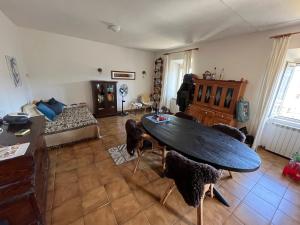 a living room with a table and chairs at Casa Belvedere in Mazzano Romano