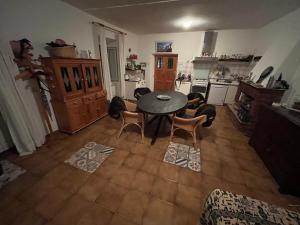 a kitchen with a table and chairs in a room at Casa Belvedere in Mazzano Romano +4 photos