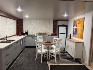 a kitchen with a small table and chairs in it at The Sanctuary on William - Nature Reserve Hideaway in Ormiston