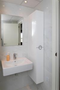 a white bathroom with a sink and a mirror at Ocean View by Mar Holidays in Arenales del Sol