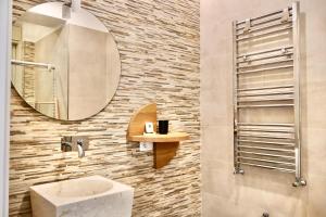 a bathroom with a sink and a mirror at TAGA Rooms in Catania +102 photos