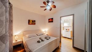 a bedroom with a bed and a ceiling fan at MAB Sweet Home By Villas Guide in Vela Luka +28 photos