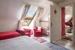 a bedroom with red furniture and a window at Villa Béatrice - Piscine in Hochfelden +45 photos