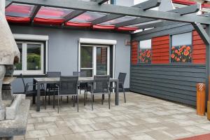 a patio with a table and chairs on a building at Ferienhaus Sieger in Salem