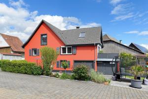 a orange house with a gray roof on a street at Ferienhaus Sieger in Salem +61 photos