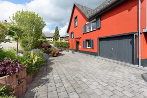 an orange house with a garage and a driveway at Ferienhaus Sieger in Salem