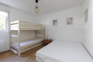 a bedroom with a bed and a bunk bed at Villa du Lac - Conciergerieland in Soustons +17 photos