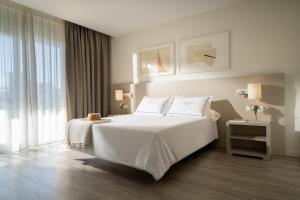 a bedroom with a white bed and a large window at Helios Benidorm in Benidorm +35 photos