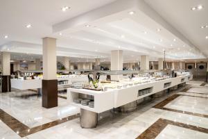 a restaurant with a buffet line in a building at Helios Benidorm in Benidorm