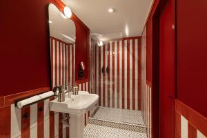 a red bathroom with a sink and a shower at TWENTYSEVEN Boutique in Budapest +30 photos