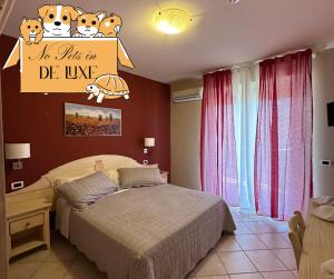 a bedroom with a bed and a sign on the wall at Le Residenze di Santa Costanza - Le Dimore in San Vincenzo