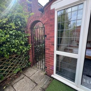 an entrance to a brick house with an iron gate at Rizvi house in Moston