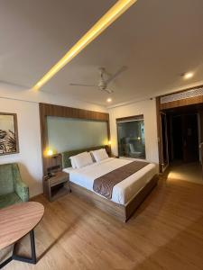 a hotel room with a bed and a chair at MANDARIN SKY in Kannur