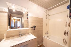 a bathroom with a sink and a tub and a mirror at L'Edelweiss - Bouvier in Aillon-le-Jeune +114 photos