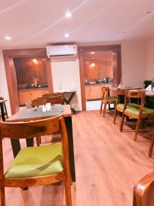 a dining room with wooden tables and chairs at The Countryside Resorts Pahalgam in Pahalgām