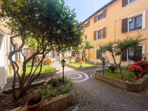 a cobblestone street with trees and a building at Piccola Corte in Fano