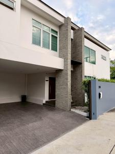 a large white house with a driveway at Pool Villa Ramkhamhaeng 9 in Bangkok