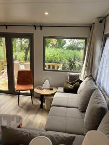 a living room with a couch and a large window at Escapade in Lège-Cap-Ferret +4 photos