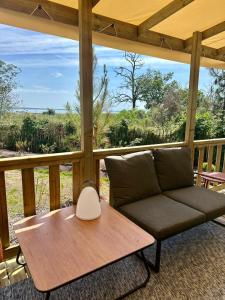 a couch sitting on a porch with a table at Escapade in Lège-Cap-Ferret