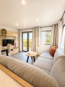 a living room with a couch and a table at Escapade in Lège-Cap-Ferret