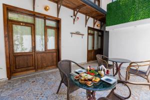 a table with a plate of food on top of it at Mai İnci Pera Hotel İstanbul in Istanbul