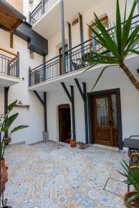 a courtyard of a house with a staircase and a palm tree at Mai İnci Pera Hotel İstanbul in Istanbul