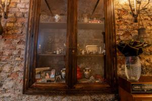 a wooden china cabinet filled with lots of items at Mai İnci Pera Hotel İstanbul in Istanbul +90 photos