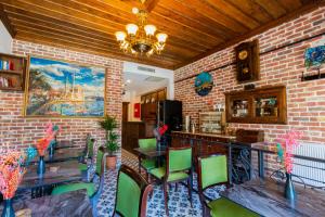 a kitchen with a table and chairs and a brick wall at Mai İnci Pera Hotel İstanbul in Istanbul
