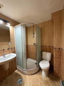 a bathroom with a shower and a toilet and a sink at Hotel IL Sole in Berane +53 photos