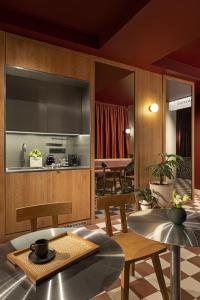 a kitchen and dining room with wooden cabinets and tables at TWENTYSEVEN Boutique in Budapest