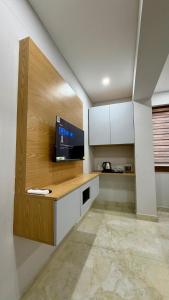 a kitchen with a counter with a tv on it at TCS SUITES Chala Bypass Kannur in Thottada